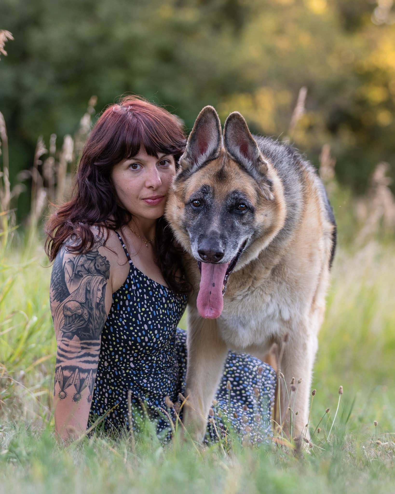 A woman sitting with her German Shepherd Dog
