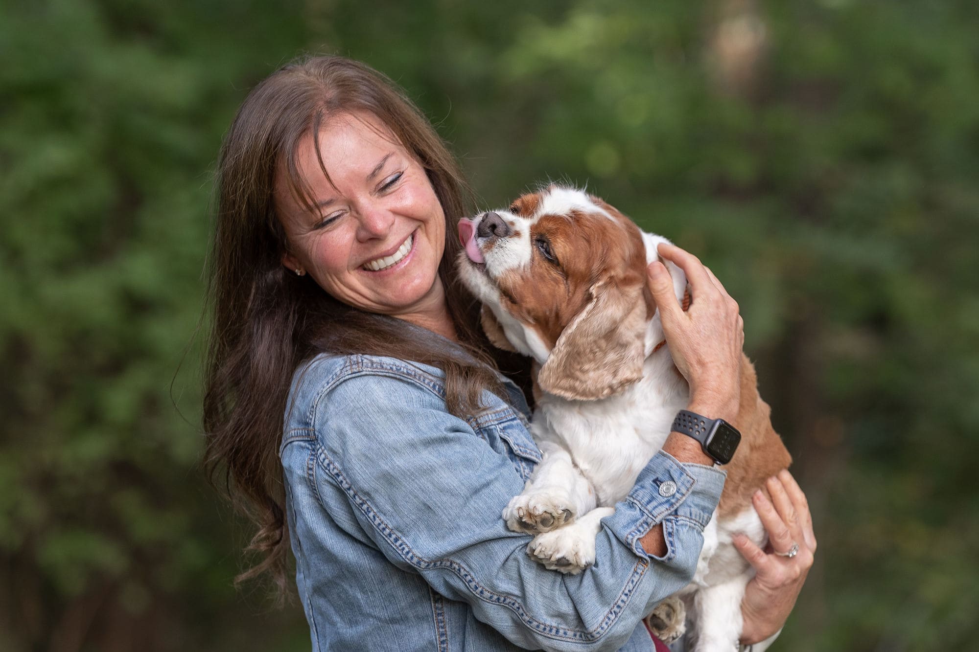 woman with dog licking her