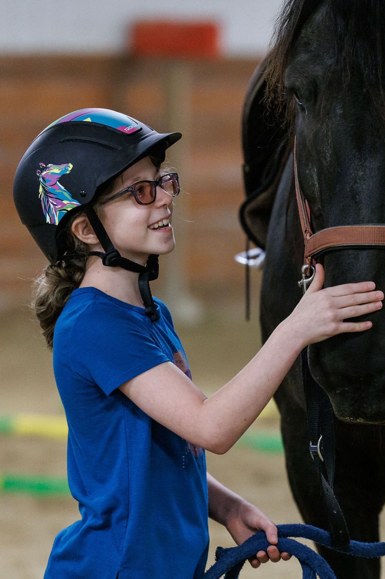 girl smiling with black horse at smiles therapeutic riding center shadow dog photography